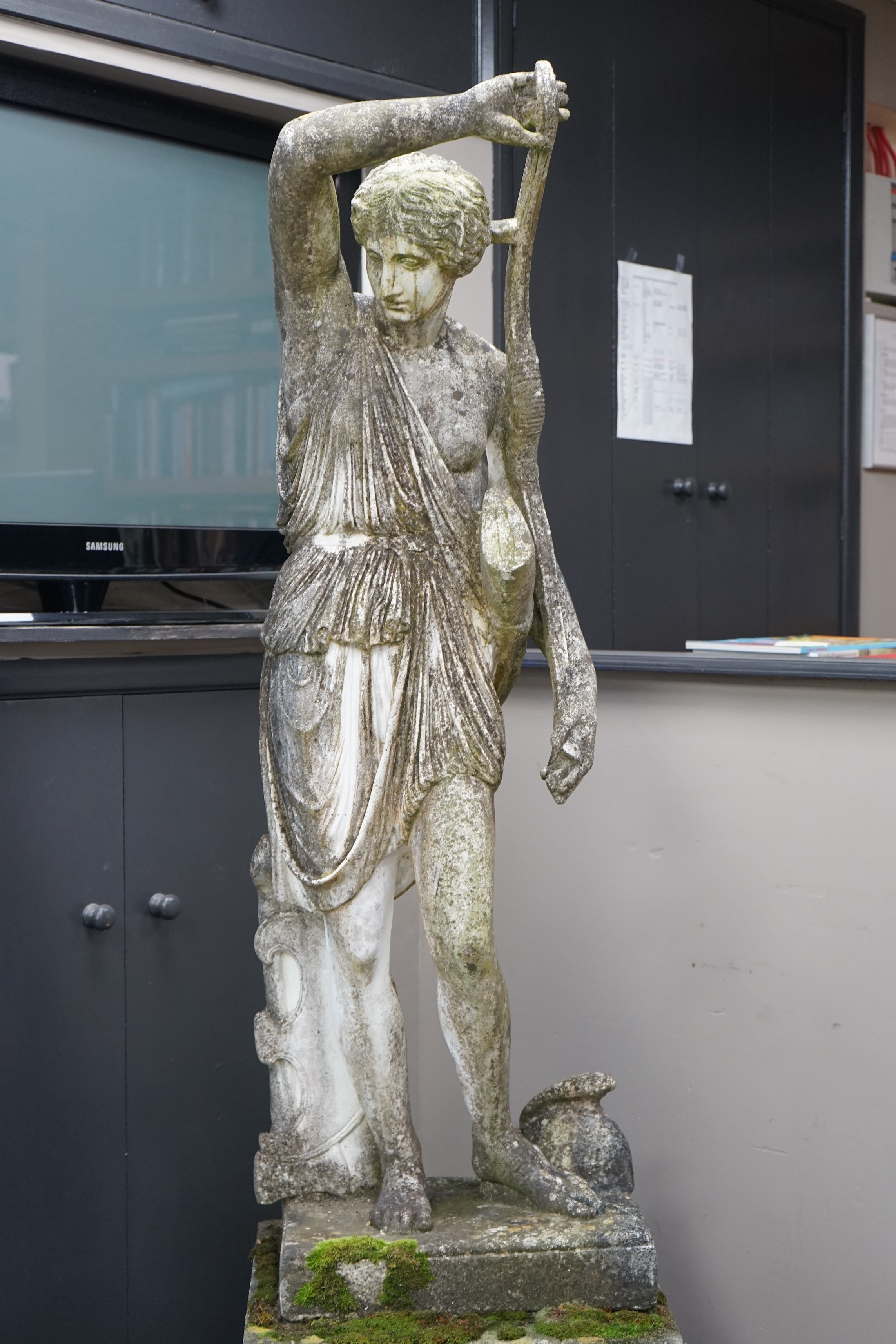 An Italian composition marble statue of Diana the Huntress, on a square reconstituted stone plinth